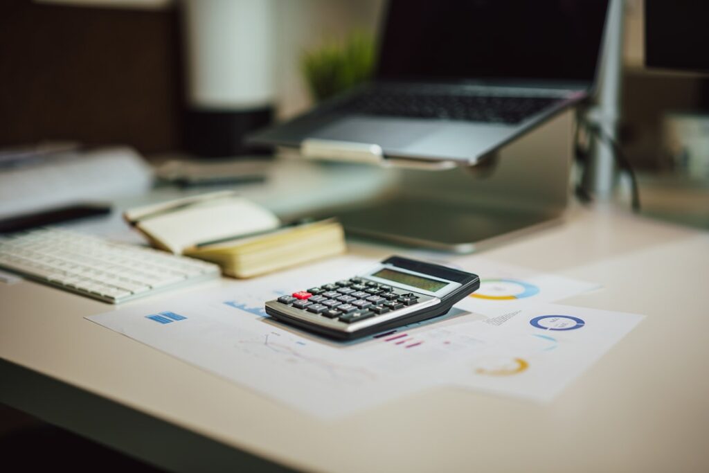 How to Read a Holiday Rental Owner Statement: A Costa del Sol Owner’s Guide 8 Calculator and paperwork used to review a holiday rental owner statement